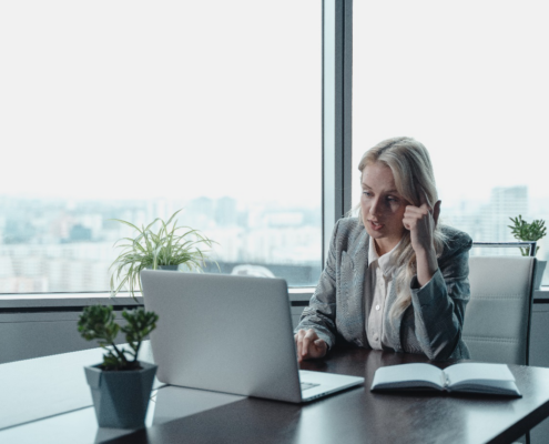 a woman sitting in front of a laptop