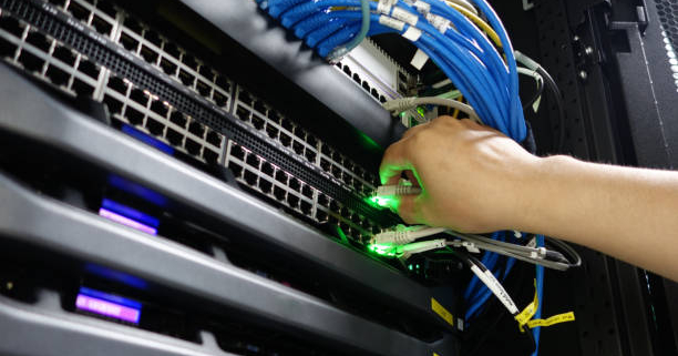 Man fixing server in data center room .