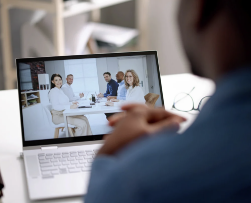 A professional attending a virtual meeting on a laptop, representing the strategic IT leadership provided by Virtual CIO Services Dallas for business growth and efficiency.