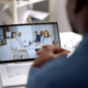 A professional attending a virtual meeting on a laptop, representing the strategic IT leadership provided by Virtual CIO Services Dallas for business growth and efficiency.