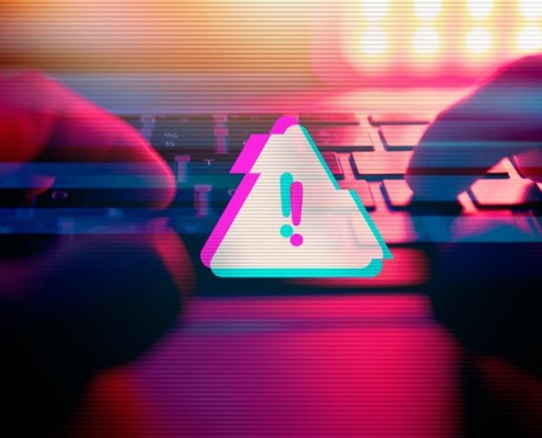 A stylized image showing hands typing on a keyboard with a glowing warning icon overlay, representing cyber threat activity. The visual includes glitch effects and intense lighting, symbolizing digital risk. Ideal for content related to unified threat management in Dallas.
